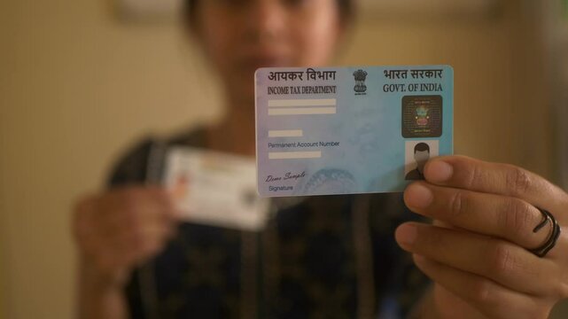Indian woman highlighting Indian PAN card and Aadhaar card, government programmes, closeup