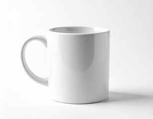Obraz premium A plain white ceramic mug with a curved handle, perfect for coffee or tea. It's a clean, simple design against a bright background