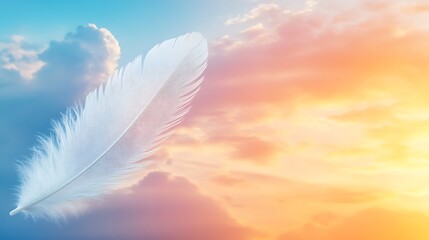 Fototapeta premium Feather floating gently against colorful dreamy sunrise sky background