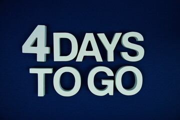 4 Days to go alphabet letters top view on navy blue background