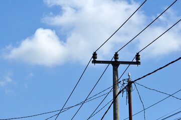 Power Lines Against a Cloudy Blue Sky