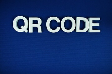 QR Code alphabet letters with space for text top view  on navy blue