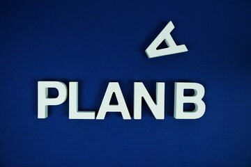 Plan B alphabet letters top view on navy blue