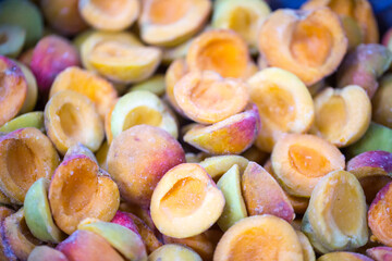 Close-up of shock-frozen ripe pink-back apricot halves with a thin ice coating. Are prepared for...