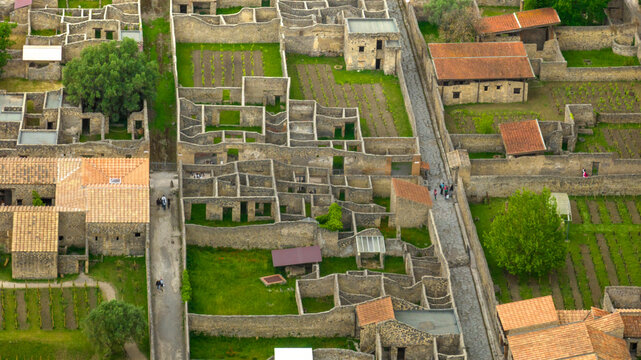 Aerial view of the ruins of houses and structures of the ancient Roman city of Pompeii. The archaeological park is located in the province of Naples, Campania, Italy.