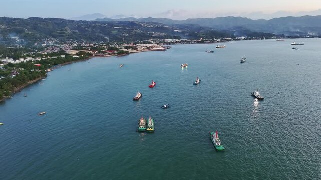 Barges and cargo ships waiting in the bay at the Mindanao Container Terminal in Cagayan de Oro, Misamis Oriental, Mindanao, Philippines.