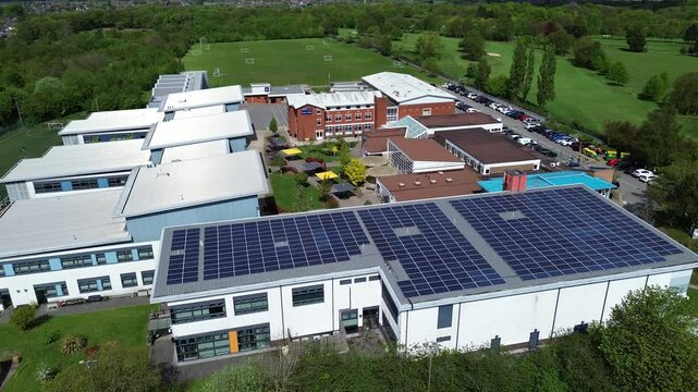Modern solar powered college faculty roof aerial view circling sustainable green energy campus