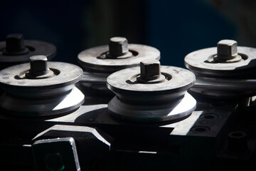 Metal rollers pulling aluminum wire