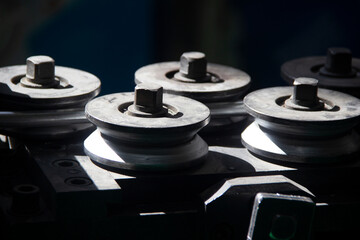 Metal rollers pulling aluminum wire