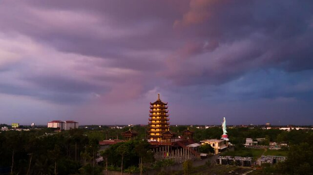 Phat Ngoc Xa Loi Pagoda. Iconic tower on the horizon with glowing blue ping skyline. Drone hyper lapse during blue hour.Copy space.