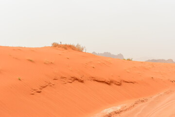 Wadi Rum Desert, Jordan. The red desert and Jabal Al Qattar mountain. 8th July 2023. On a hot spring cloudy day. 