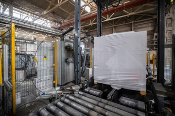 Industrial production of aerated concrete blocks, AAC blocks (Autoclaved aerated concrete), Grey Cement Fly Ash Bricks. Finished products are stacked on wooden pallets and packed in plastic wrap.
