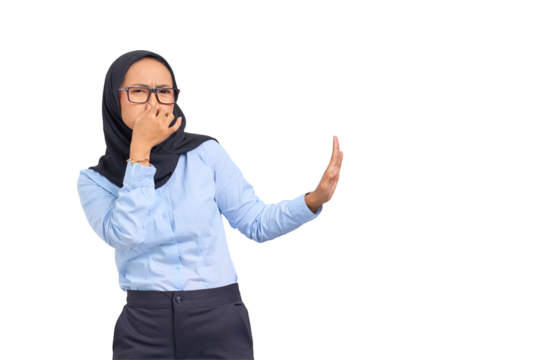 Portrait of annoyed young Asian woman makes stop gesture, covering her nose with hand isolated on transparent background