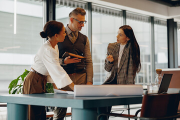 A diverse group of professionals actively participating in discussion and collaboration at a modern workspace