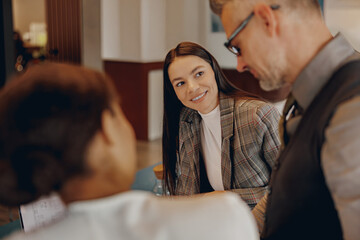Three skilled professionals engage in a vibrant discussion, demonstrating effective collaboration...