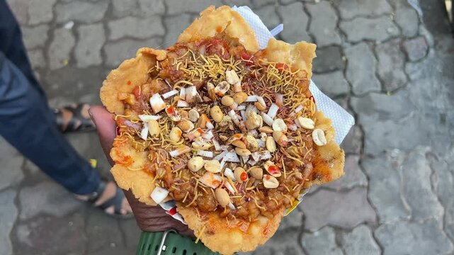 Papri chat prepared with different types of spices and nuts in the street of Kolkata.