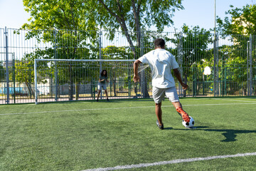 Soccer player kicking ball into goal during penalty kick