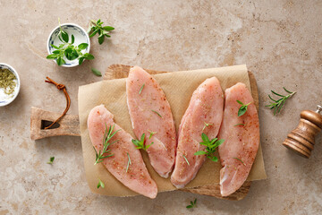 Meat. Raw turkey tenderloin meat, turkey steaks with ingredients for cooking, top view