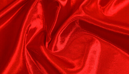 Obraz premium Luxurious red satin fabric with smooth flowing folds creates abstract background, evoking sensual texture that captivates senses
