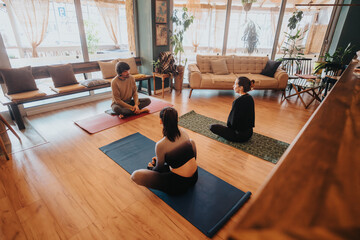 Instructor and students engage in a mindful yoga session indoors, set within a warm and welcoming environment featuring soft lighting, wooden floors, and comfortable seating.