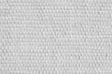 Texture of white natural fabric with large weaving. Surface, structure of upholstery or carpet material, cloth background close up.