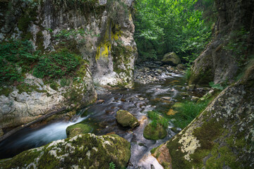 A river patiently carves its way through the hard granite rock
