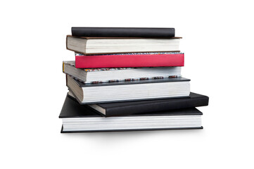 A front side on view of a pile of seven black study books, textbooks and one red book on a table isolated against a transparent background