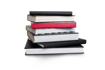 A front side on view of a pile of seven black study books, textbooks and one red book on a table isolated against a transparent background