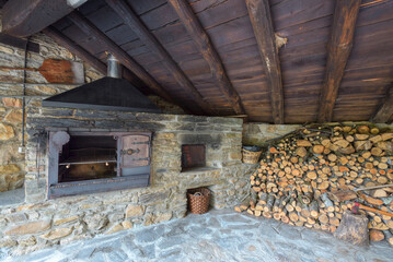 Traditional woodshed space with barbecue and wood oven