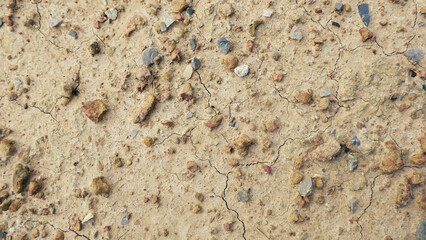 Ground texture background with small stones and gravel mixed in.