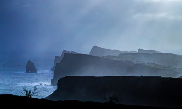 windmills in a dramatic landscape green enery