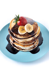 Pancakes with chocolate and fruit isolated on white background