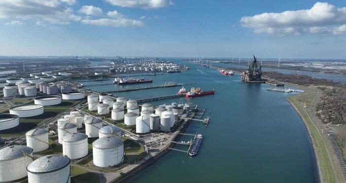 Europoort, Rotterdam, tank, storage silos, fossil fuels and energy, shipping and transport industry over water. North Sea, The Netherlands. Aerial view.