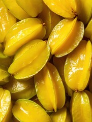 Bright yellow starfruits piled together in a vibrant display at a local market