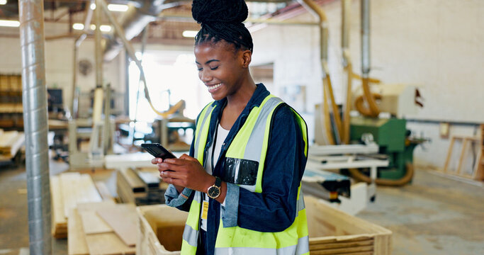 Phone, woman and carpenter in workshop for woodwork, stock storage or text for furniture production. African worker, technology and engineer in warehouse for manufacturing, joinery and message online - Powered by Adobe