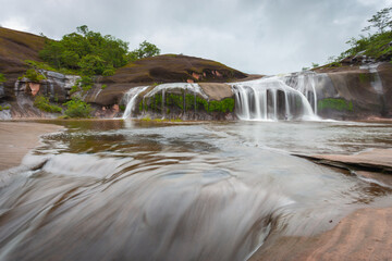 The grand beauty and fun water play and slides of Tham Phra Waterfall in the rainy season, Bueng...