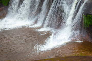 The grand beauty and fun water play and slides of Tham Phra Waterfall in the rainy season, Bueng...