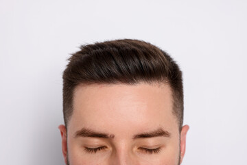 Fototapeta premium Man after hair loss treatment on light background, closeup