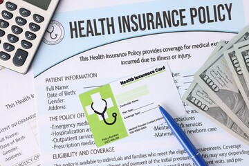 Medical insurance card, policy, money, calculator and pen, closeup