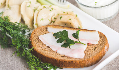 Ukrainian bacon sandwich and traditional vareniki (dumplings) with potatoes. Ukrainian food