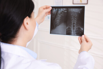 Doctor examining neck MRI scan in clinic