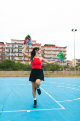 Obraz premium Cheerleader Girl Cheers Her Team On The Basketball Court