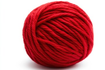 Bright red yarn ball used for knitting during crafting session at home on a sunny afternoon
