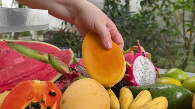 cut delicious tropical fruits healthy food mango bananas passion fruit watermelon oranges and other juicy Asia palm leaves in the background