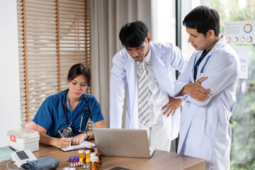 Medical professionals engaged in a collaborative analysis of patient data