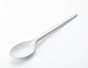 Simple white spoon laying diagonally on a white surface, casting a subtle shadow