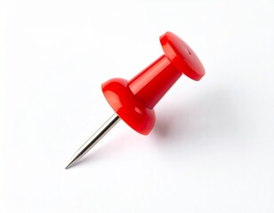 Red pushpin lying diagonally on a white surface, casting a soft shadow