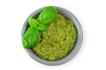 Pesto sauce in ceramic bowl isolated on white background. Top view. Flat lay.
