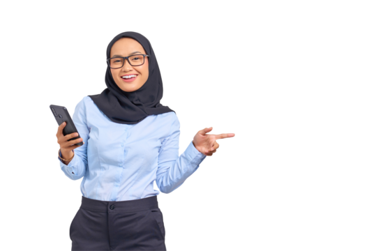 Portrait of cheerful young Asian woman holding mobile phone and pointing finger away at copy space isolated on transparent background