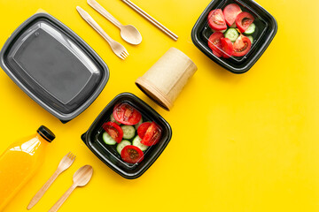 Healthy food delivery in takeaway boxes with and disposable cutlery, top view